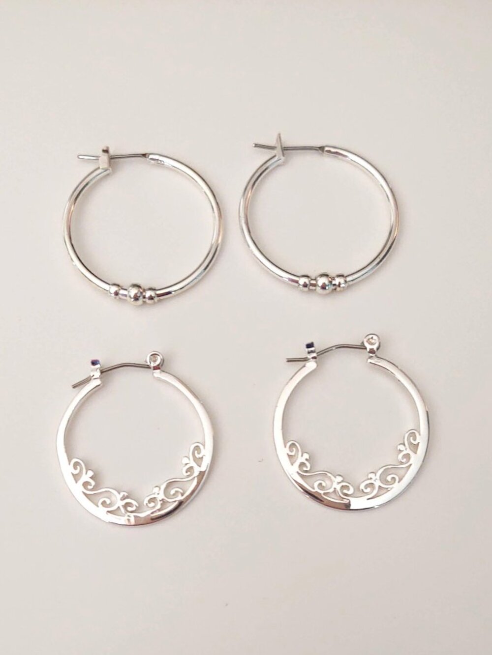 2 pairs of silver tone hoop earrings